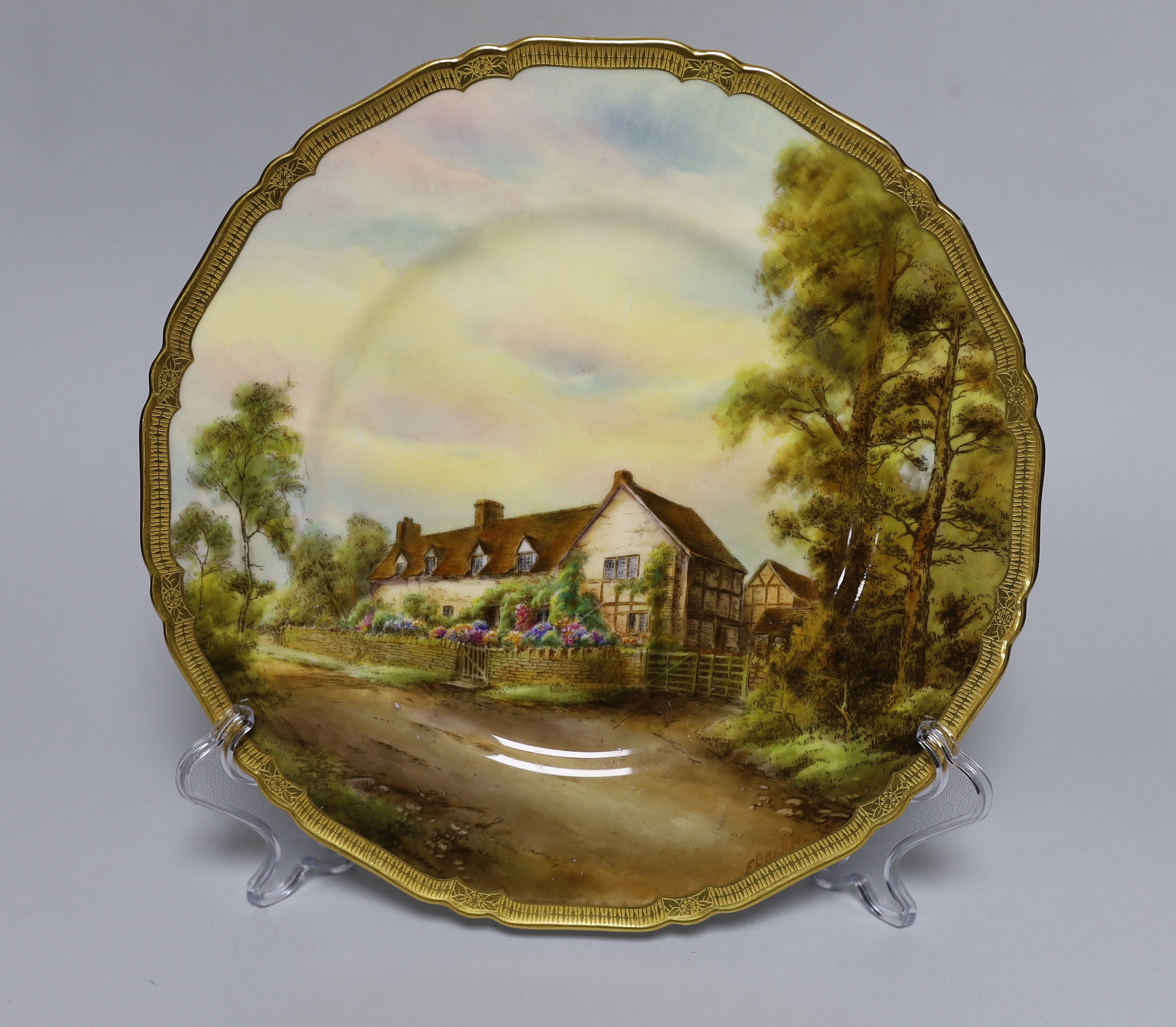 A Royal Worcester plate painted with Mary Arden's House by E. Barker, signed, date mark for 1929